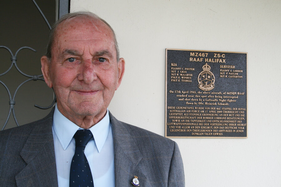 Joe Hollins next to the MZ-467 memorial plaque